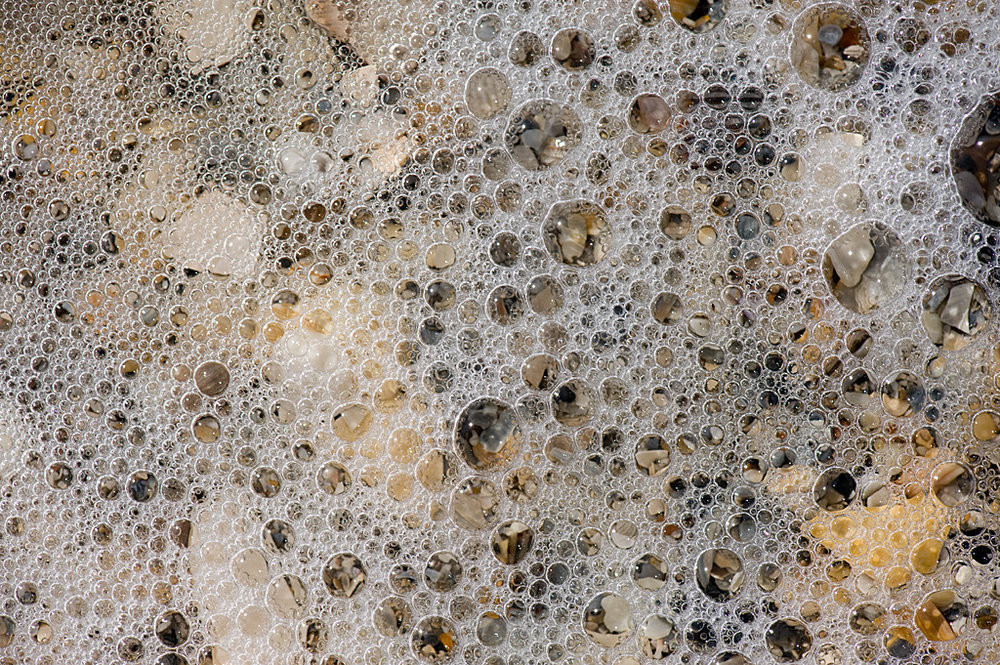 Clear: ocean surf offers glimpses through the bubbles at the shells below