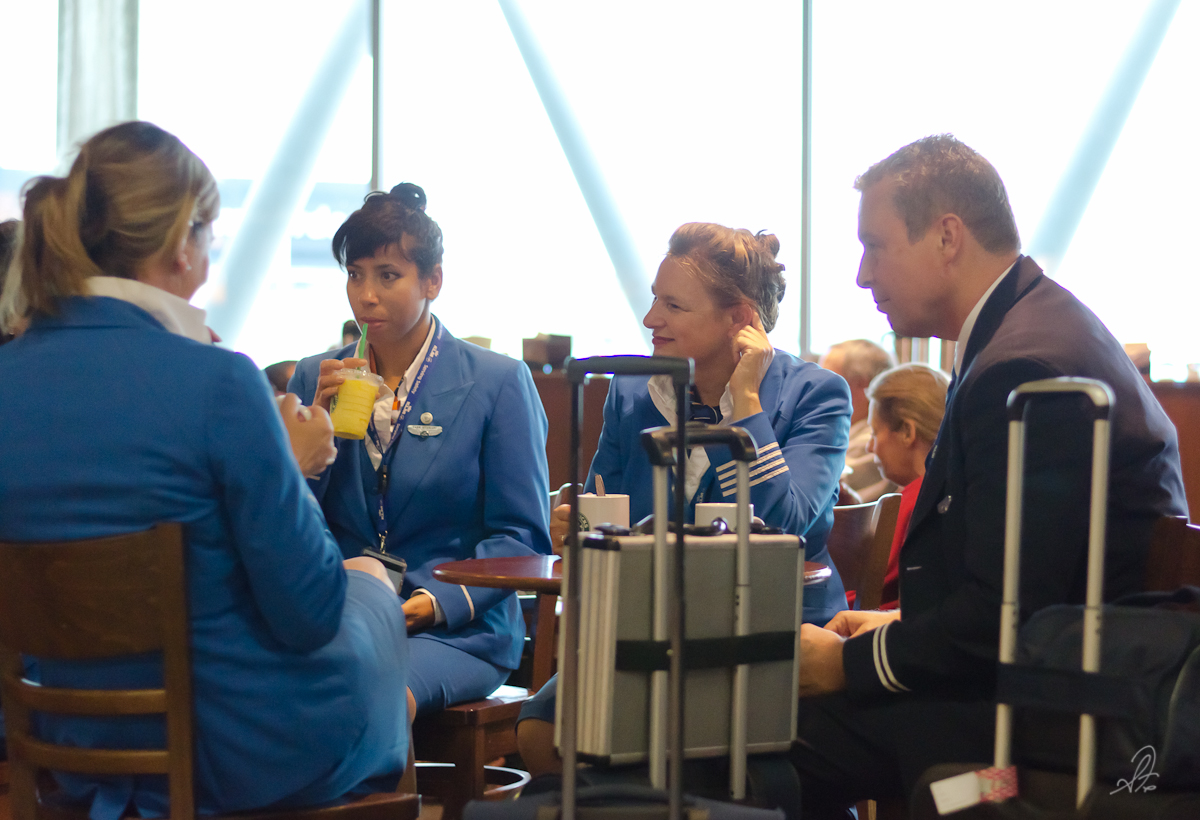 KLM flight crew relaxes at Starbucks before catching their flight